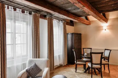 a living room with chairs and a table and windows at Boutique Hotel Bijou de Prague in Prague