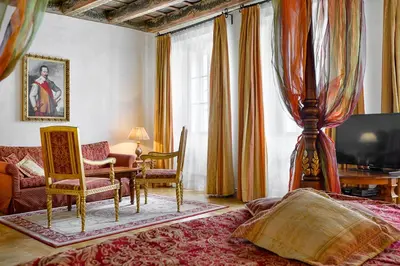 a bedroom with a bed and a table and chairs at Boutique Hotel Bijou de Prague in Prague
