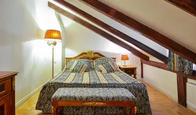 a bedroom with a bed in a attic at Boutique Hotel Bijou de Prague in Prague