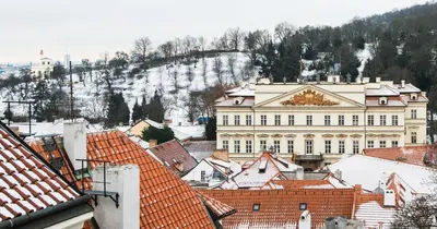 a view of a large building with snowy roofs at Boutique Hotel Bijou de Prague in Prague