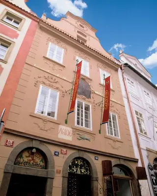 a building with red signs on the front of it at Boutique Hotel Bijou de Prague in Prague