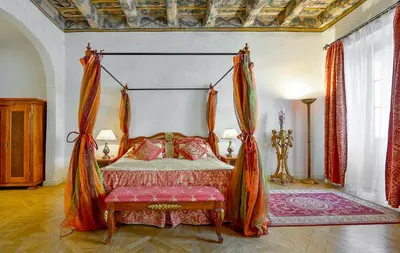 a bedroom with a bed and a tv in it at Boutique Hotel Bijou de Prague in Prague