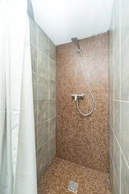 a bathroom with a shower with a shower curtain at Budyně Apartment in Budyně nad Ohří