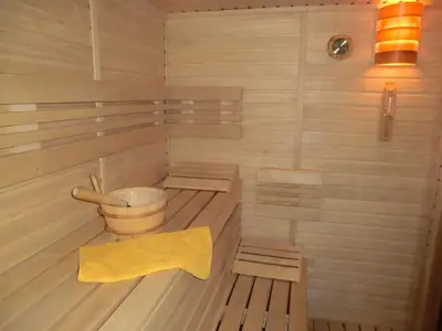 a sauna with benches and a yellow towel in it at Pension Rondel in Poděbrady