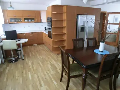 a kitchen with a table and chairs and a refrigerator at Pension Rondel in Poděbrady