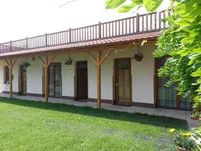 a house with glass doors and a grass yard at Pension Rondel in Poděbrady