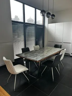 a dining room with a table and chairs and windows at Palace Resort Jíloviště in Jíloviště