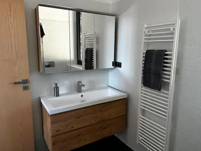 a bathroom with a sink and a mirror at Palace Resort Jíloviště in Jíloviště