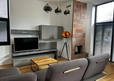 a living room with two chairs and a television at Palace Resort Jíloviště in Jíloviště