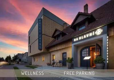 a building with a sign that reads i hour free wellness the end at Hotel Frýdl in Prague