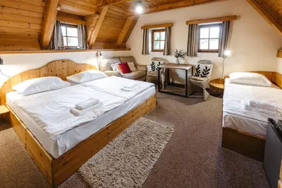 a bedroom with a bed and a couch at Hotel Frýdl in Prague