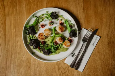 a bowl of food with meat and vegetables on a table at Hotel Frýdl in Prague