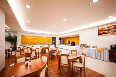 a restaurant with wooden tables and chairs and a bar at Hotel Pivovar in Prague