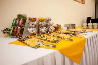 a table with a yellow table cloth with food on it at Hotel Pivovar in Prague