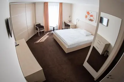 a hotel room with a bed and a mirror at Hotel Pivovar in Prague