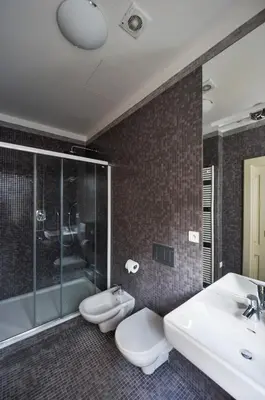 a bathroom with two toilets and a sink and a tub at 18th CENTURY BAROQUE RESIDENCE in Prague