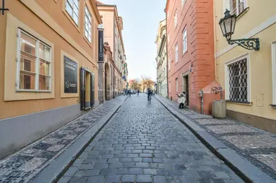a cobblestone street in a city with buildings at 18th CENTURY BAROQUE RESIDENCE in Prague