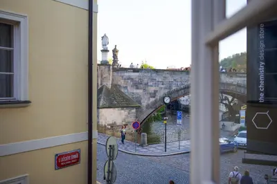 a view from a window of a street with a bridge at 18th CENTURY BAROQUE RESIDENCE in Prague