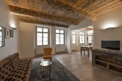 a living room with a couch and a fireplace at 18th CENTURY BAROQUE RESIDENCE in Prague