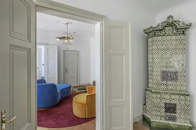 a living room with a blue couch and a chair at W Prague in Prague