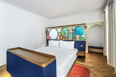 a bedroom with a bed with a stained glass window at W Prague in Prague