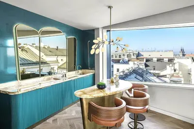 a room with a table and chairs and a large window at W Prague in Prague