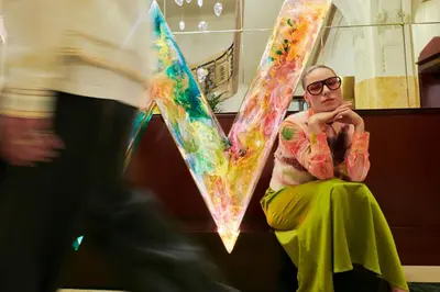 a man sitting on a bench with a tie dye shirt at W Prague in Prague