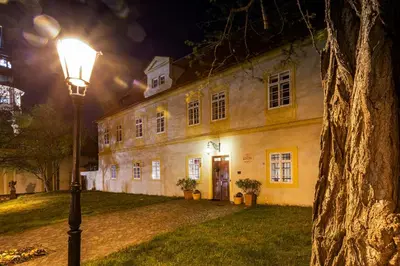 a street light in front of a building at night at Loreta Hotel in Prague