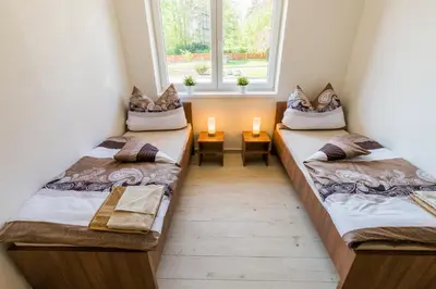 two beds in a room with two candles on them at Penzion Piranha in Mělník