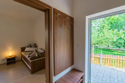 a room with a door leading to a bedroom with a window at Penzion Piranha in Mělník