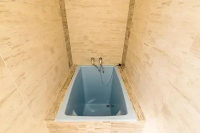 a blue bath tub in a tiled bathroom at Penzion Piranha in Mělník