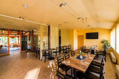 a dining room with wooden tables and chairs at Penzion Piranha in Mělník