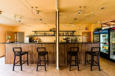 a bar in a restaurant with stools at Penzion Piranha in Mělník