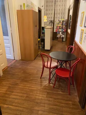 a table and two chairs and a table in a store at Hostel EMMA in Prague