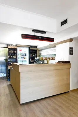 a bar in a restaurant with a counter at Hotel Soudek in Poděbrady