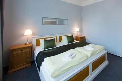 a bedroom with a bed with two towels on it at Hotel Soudek in Poděbrady