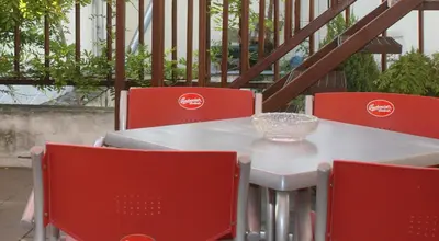 a table with red chairs and a glass bowl on it at Hotel Soudek in Poděbrady