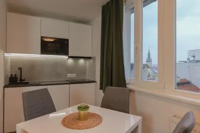 a living room with a couch and a table at Krakovka Residence in Prague