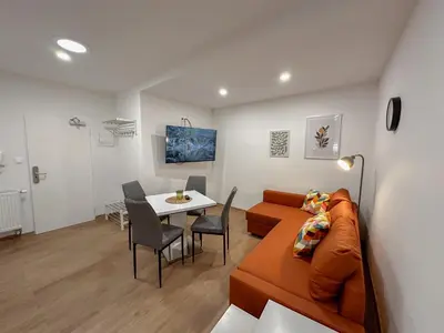 a remote control and a potted plant on a table at Krakovka Residence in Prague