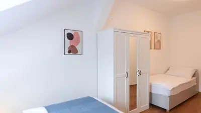 a bedroom with a bed and a mirror at Krakovka Residence in Prague