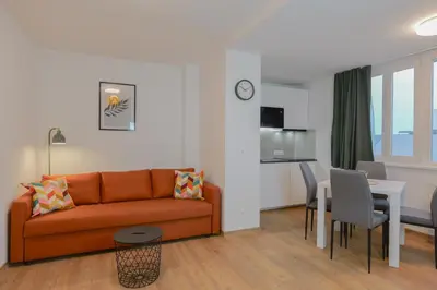 a bedroom with two beds and a couch at Krakovka Residence in Prague