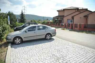 a silver car parked on the side of a street at Penzion U Tulaka in Dobřichovice