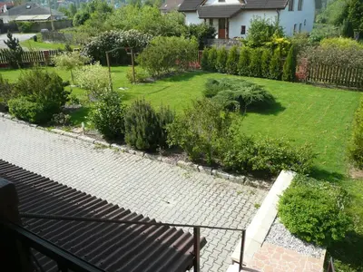 a view of a garden from the balcony of a house at Penzion U Tulaka in Dobřichovice