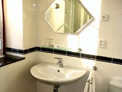 a white bathroom with a sink and a mirror at Villa Olivia in Prague