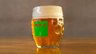 a glass of beer with the word mimx on it at Pivotel MMX in Dobřichovice