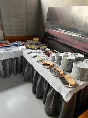a long table with plates and dishes on it at Pivotel MMX in Dobřichovice