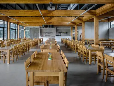 a large dining room with wooden tables and chairs at Pivotel MMX in Dobřichovice