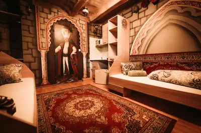 a room with two beds and a painting on the wall at Resort Svět in Úžice