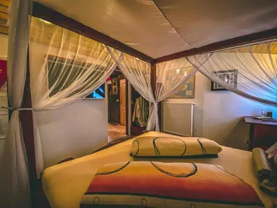 a bedroom with a bed with curtains on it at Resort Svět in Úžice