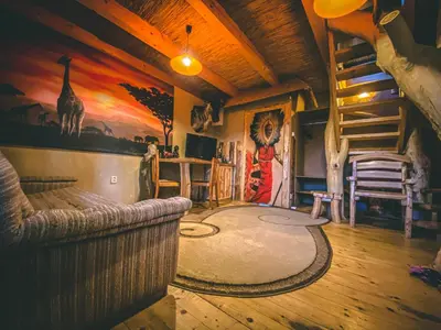 a living room with a couch and a giraffe mural at Resort Svět in Úžice